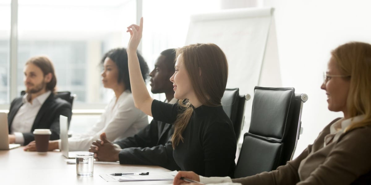 business woman volunteers at a board meeting