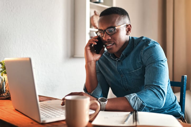 man talking on the phone to colleague