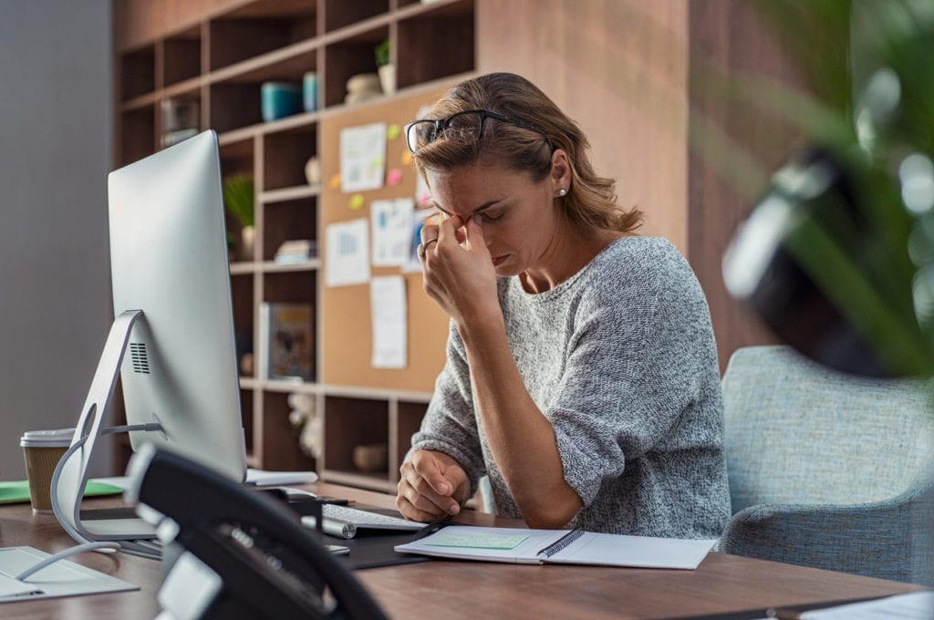 Business woman having headache at office