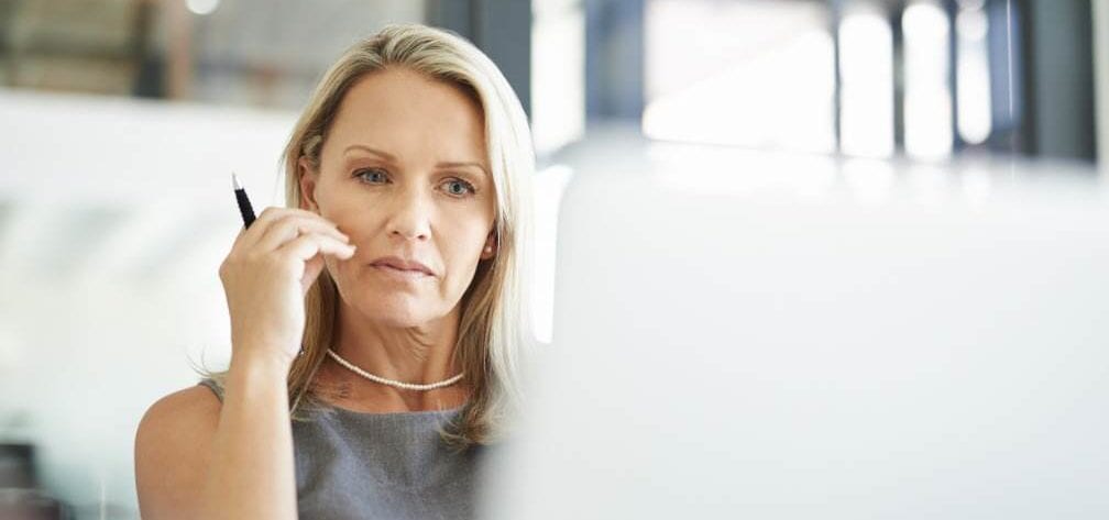 Woman thinks deeply to solve a problem at work