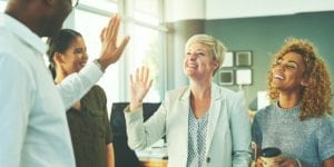 Colleagues smile and high-five