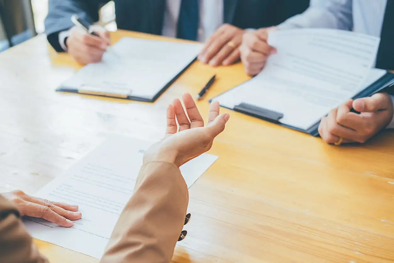 Image depicting three expressive people's hands at meeting