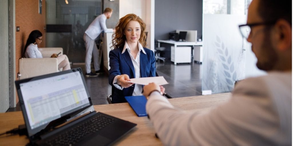 young business woman handing in CV