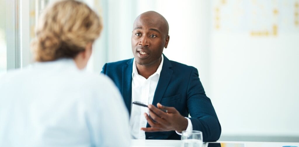 Male and female having a one on one conversation in an office