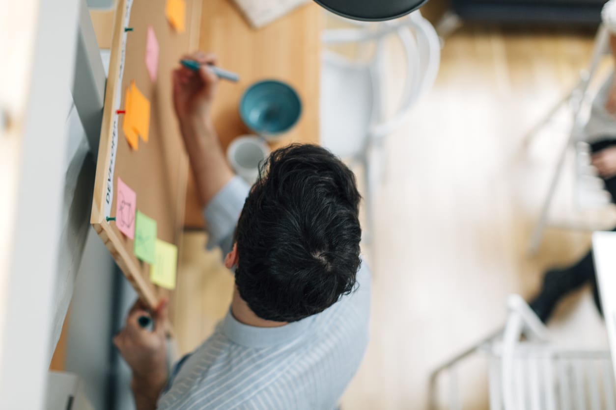 boss writing notes on post-it notes