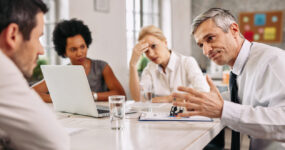 Angry businessman discussing with colleague during a meeting in the office.