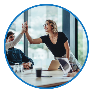 Two people high fiving in a meeting