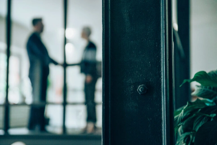 Blurred out image of two people shaking hands after a job interview success