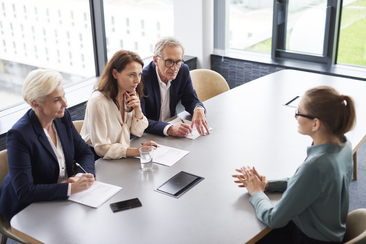 Three employees interviewing possible job prospect