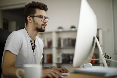 Male working on computer focused