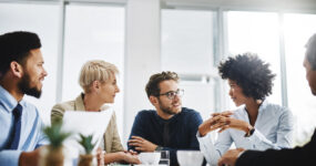 Mixed group of employees speaking to each other