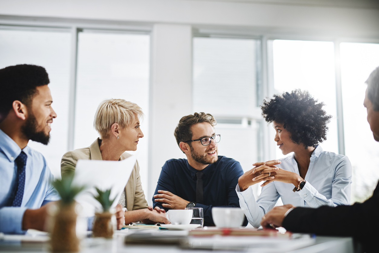 Mixed group of employees speaking to each other