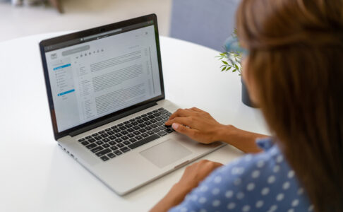 Cropped image of womens hands on a laptop