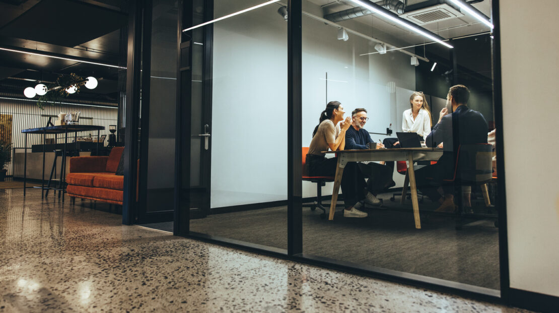 Group of employees in a private meeting room having a meeting