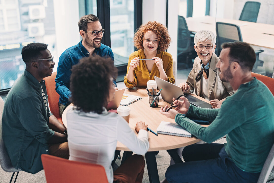 Circle of employees having a meeting on a small table