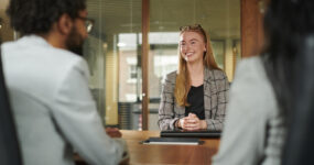 Two employees interviewing a prospect