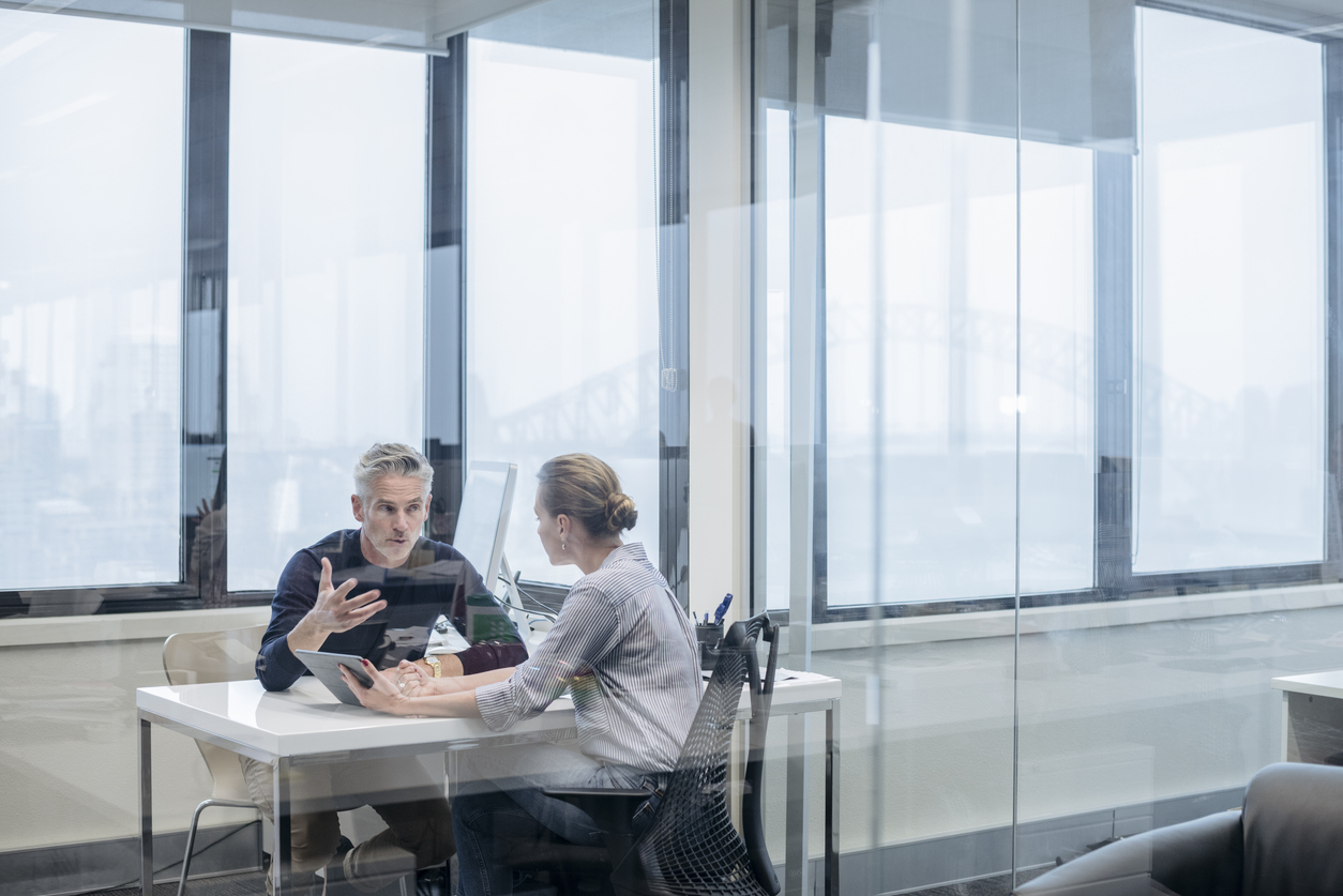 Two employees having a meeting in a private meeting room