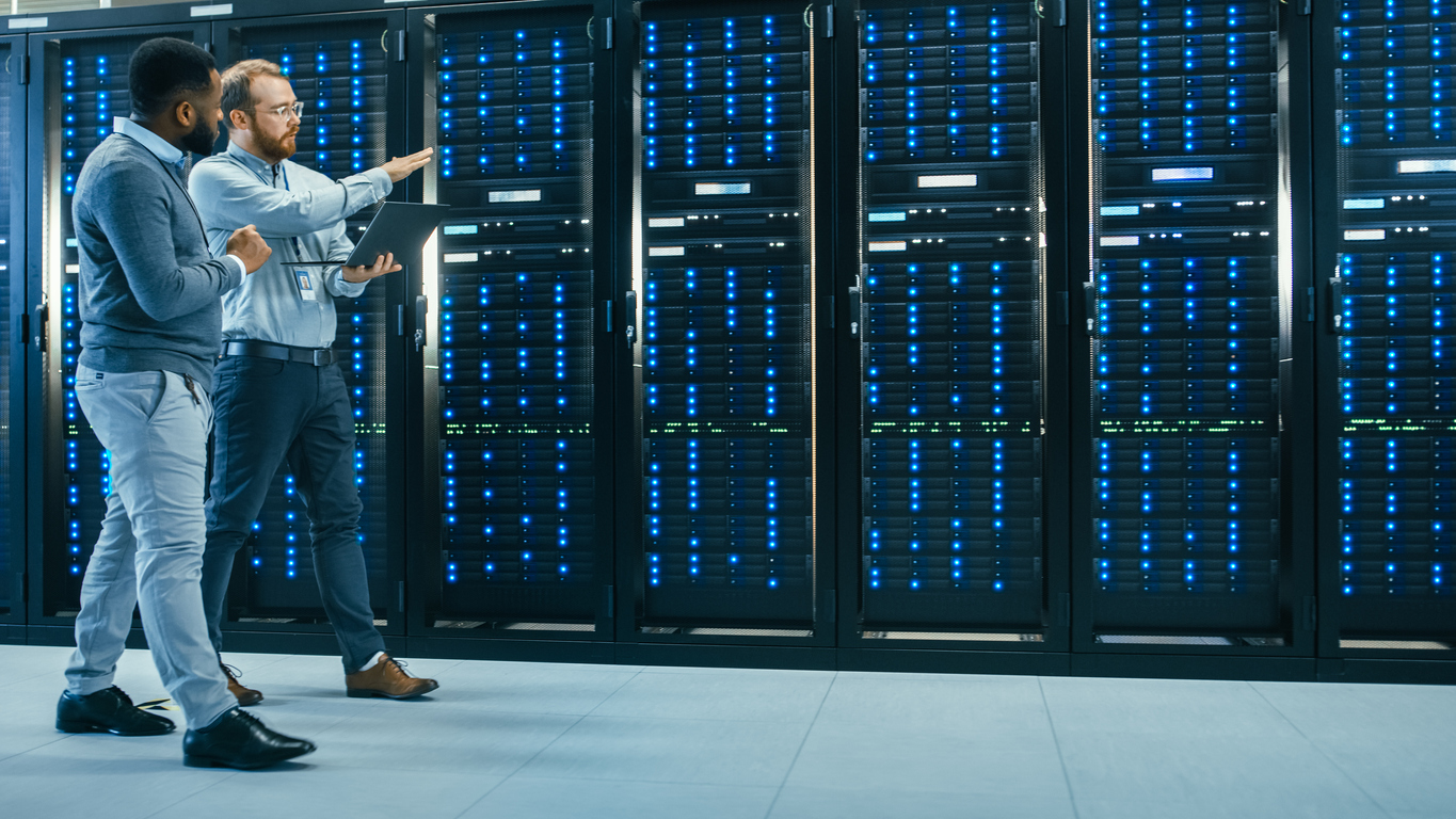 Two males walking alongside servers