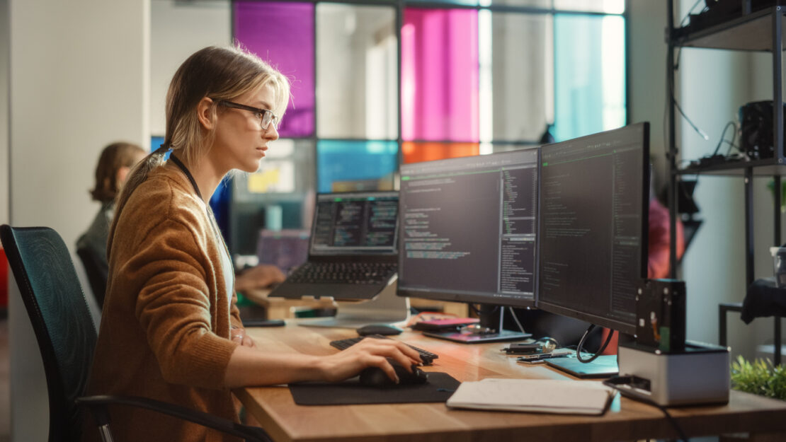 Female worker concentrating closely on coding