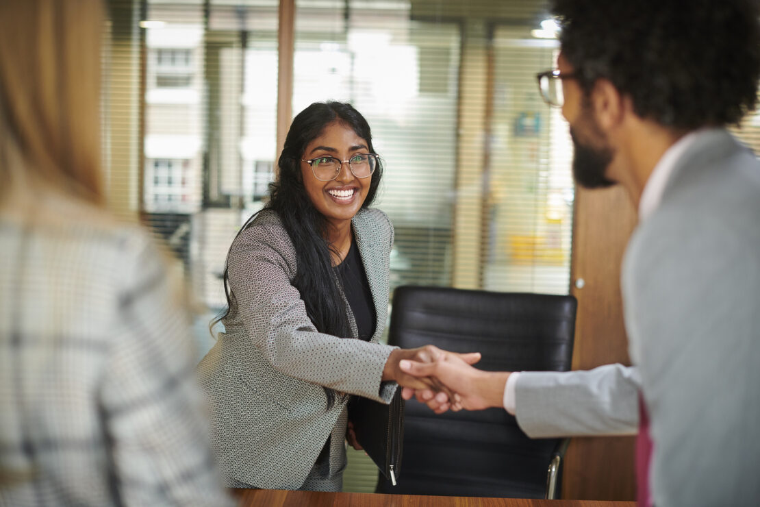 Female job candidate shaking hands with possible boss 