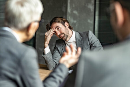 man being given bad news in an interview