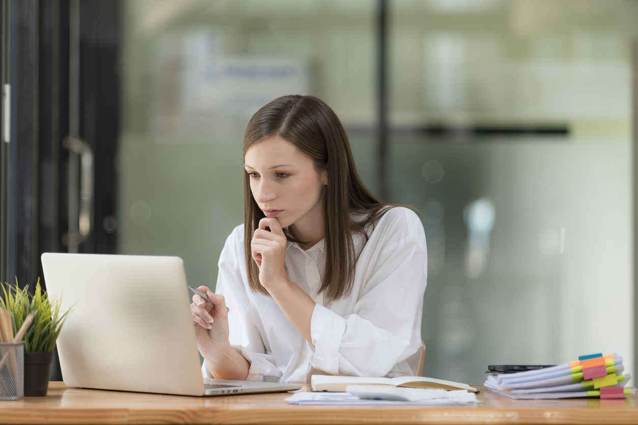 Businesswoman thinking about work while sitting at her office desk.